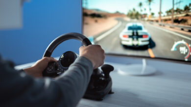 The gamer sitting at the table and gaming