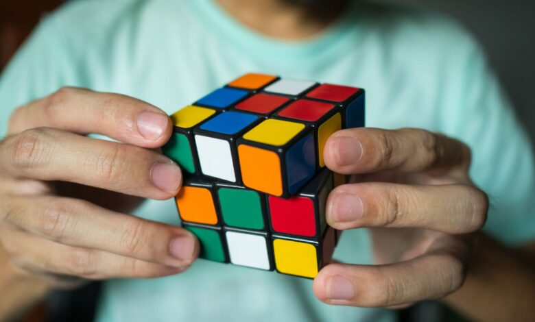 Bangkok, Thailand - March 27, 2018 : A man solving Rubik's cube.